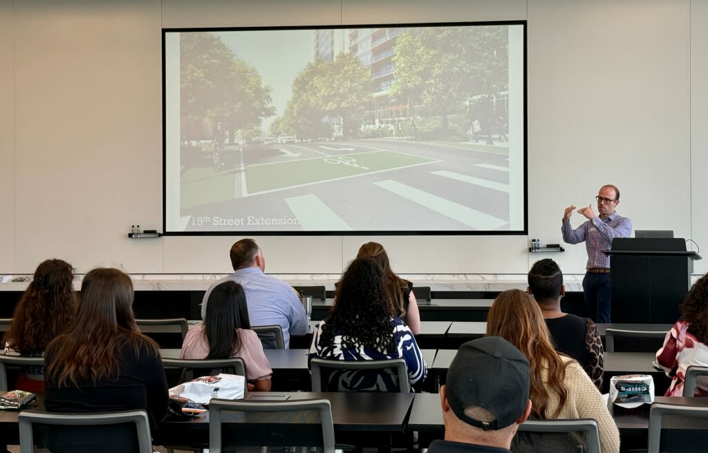 A presenter walks the audience through transportation updates